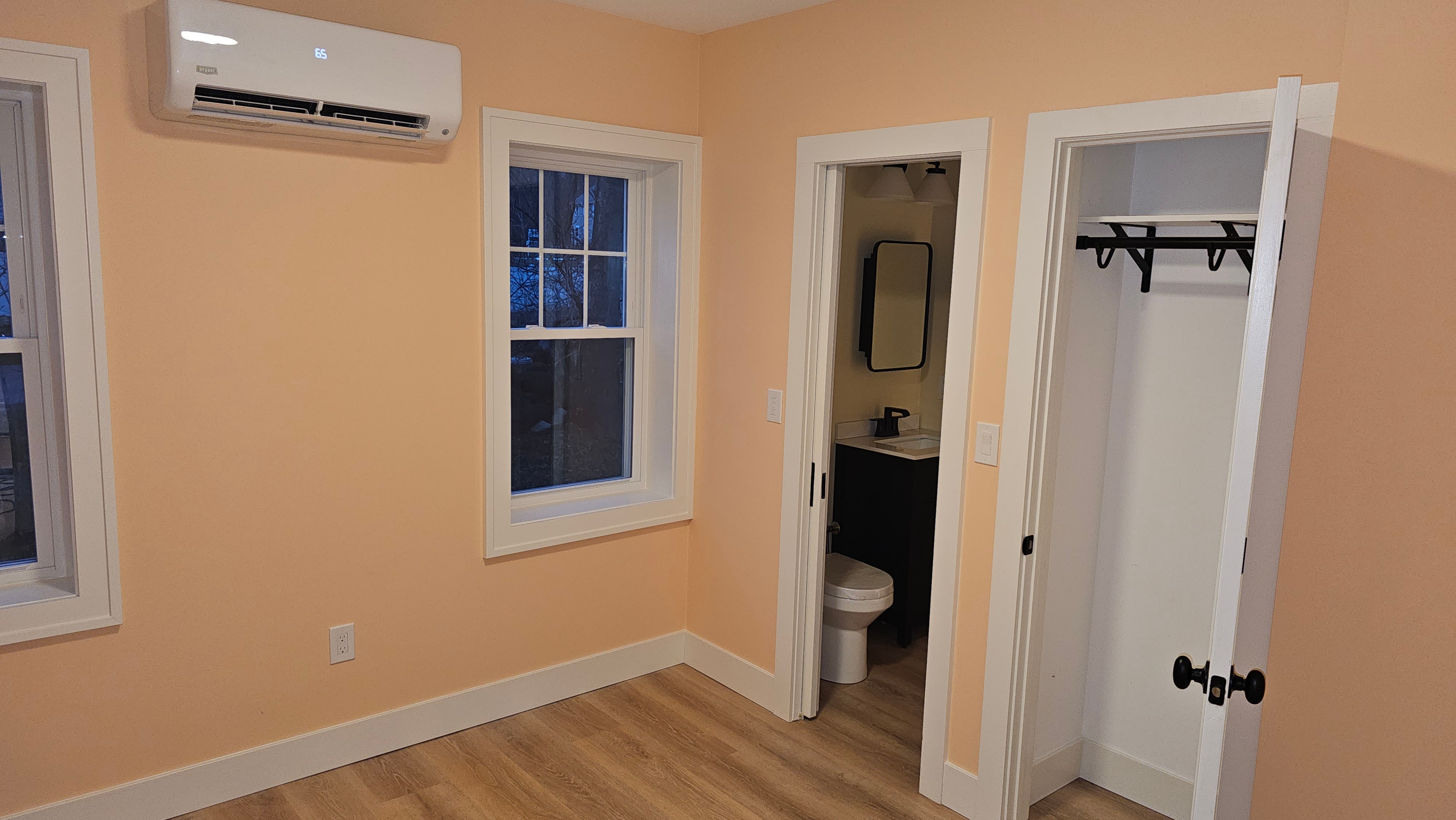 Interior painting — freshly painted bedroom with clean trim and closet doors