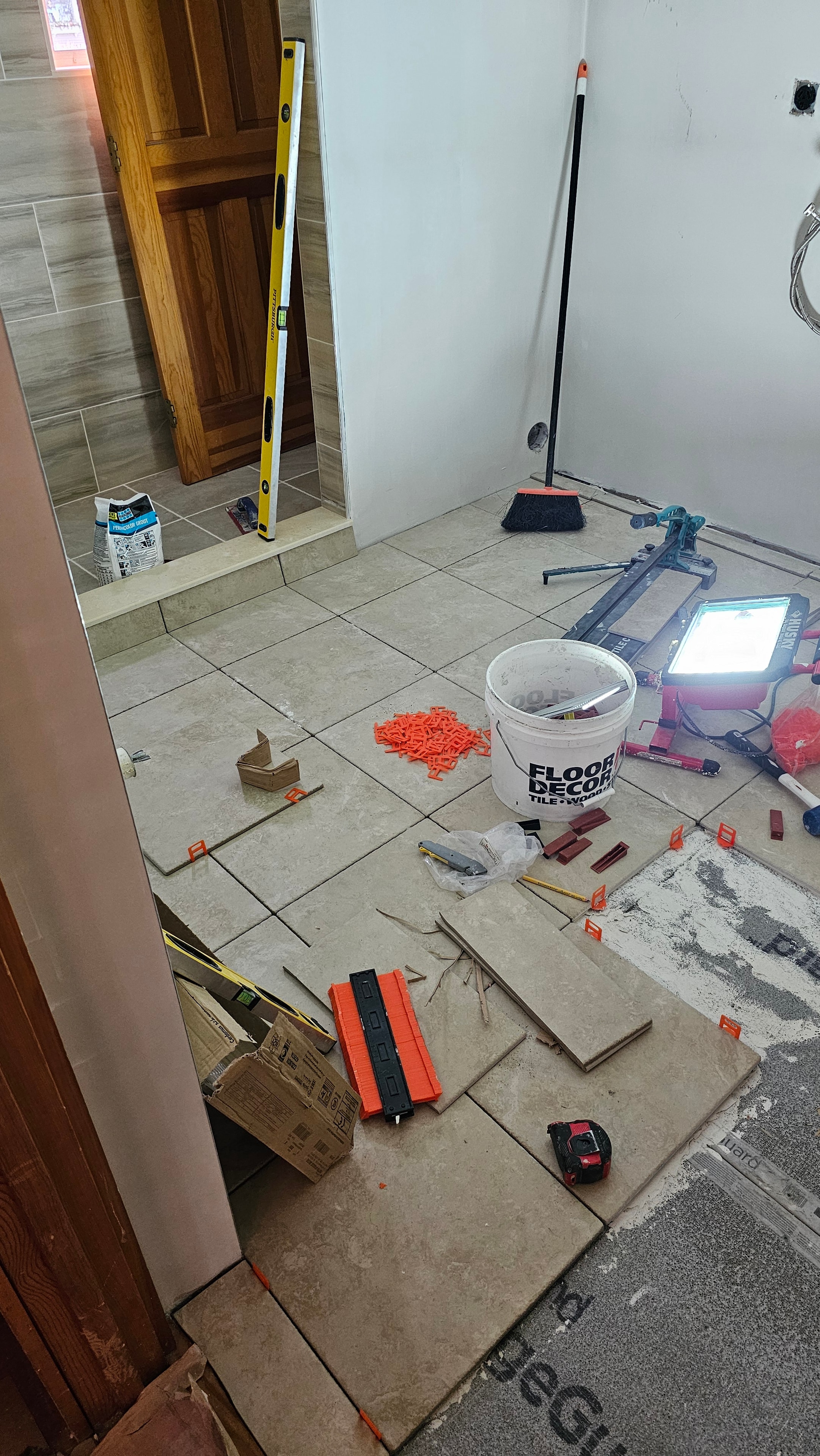 Large-format wood-look porcelain floor tile installation in progress