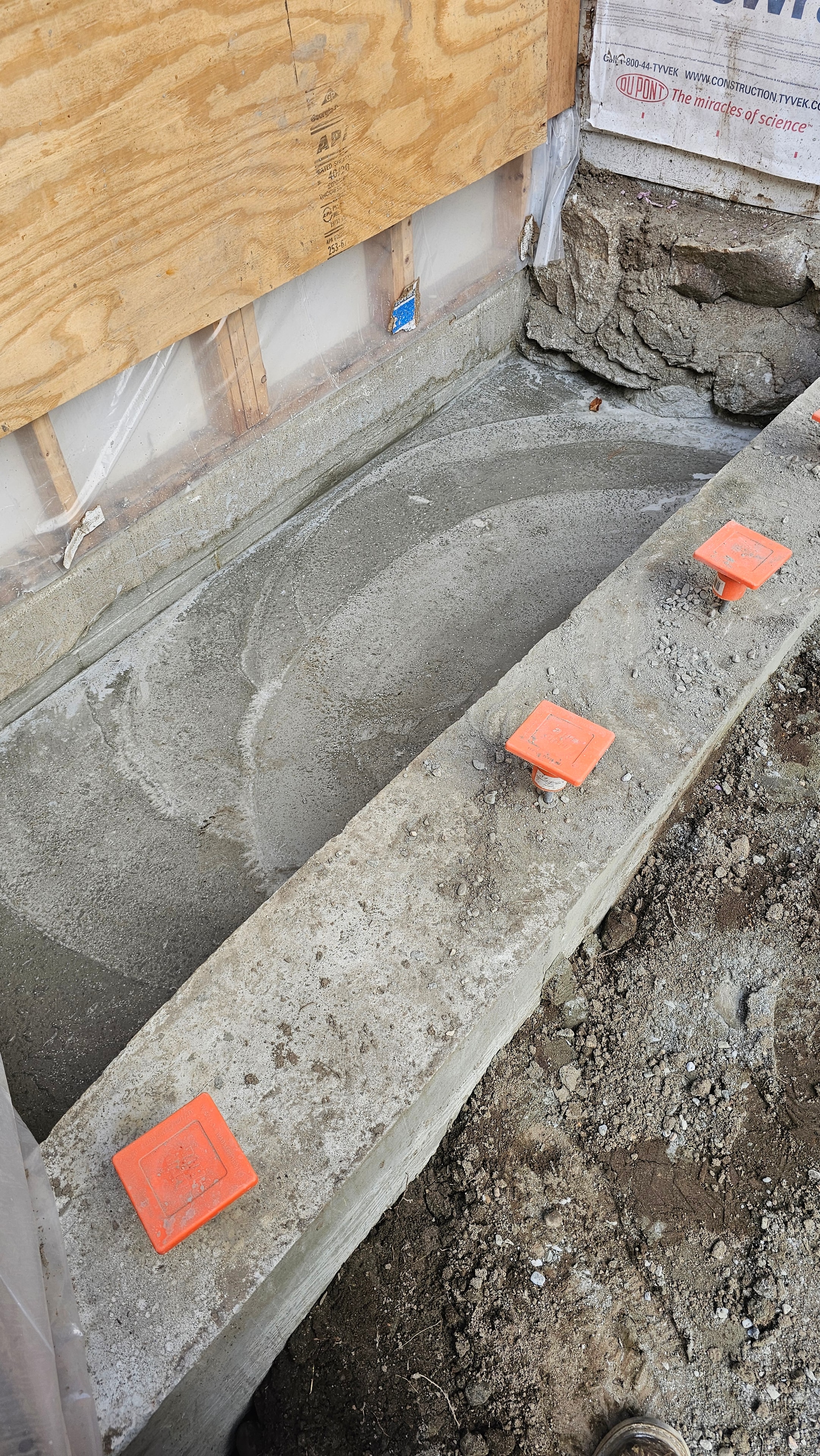 Freshly poured concrete foundation for bathroom extension