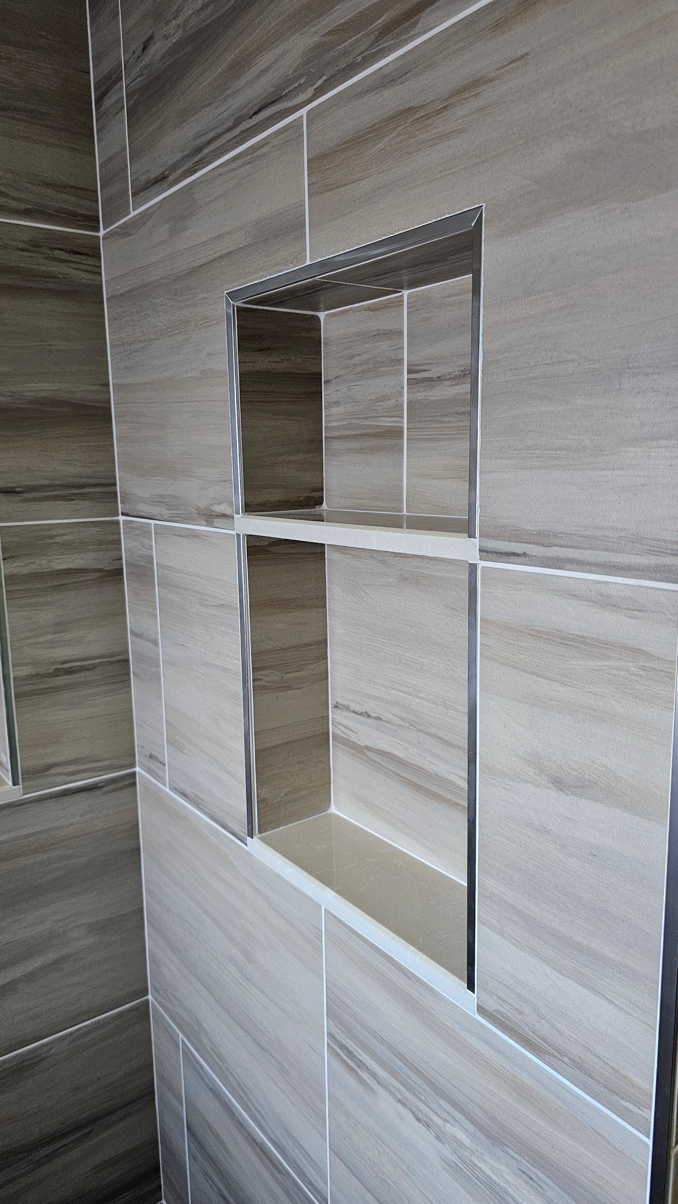 Double tiled shower niche installed