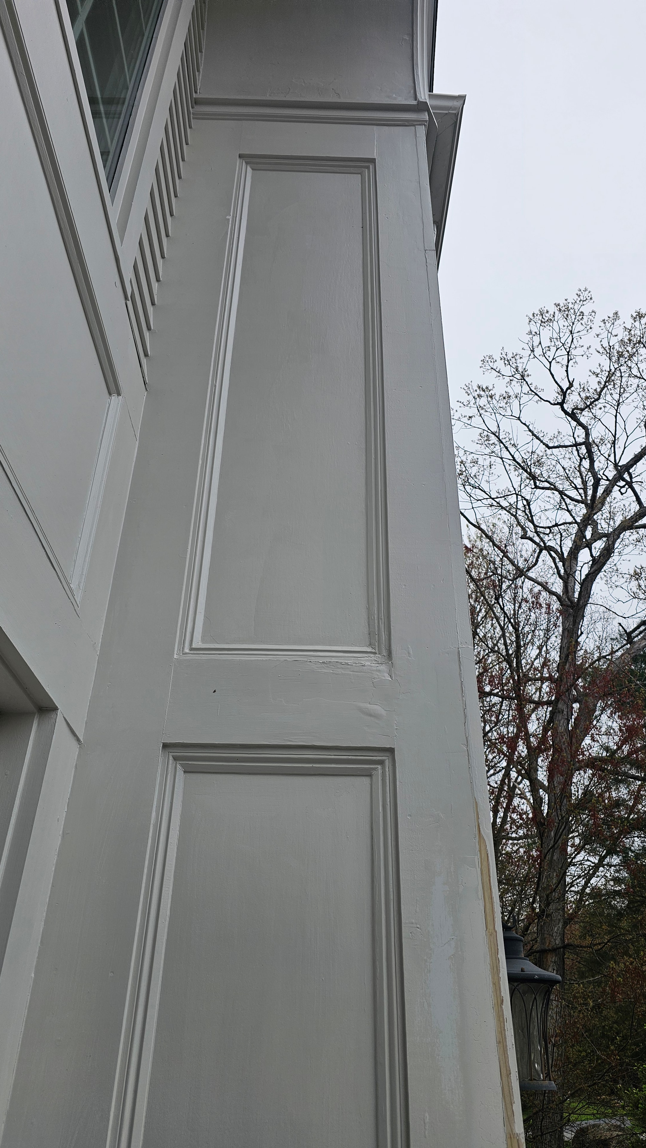 The same corner trim area on the Natick property after epoxy repair, with the damaged area filled, shaped, and painted to match the surrounding surface.