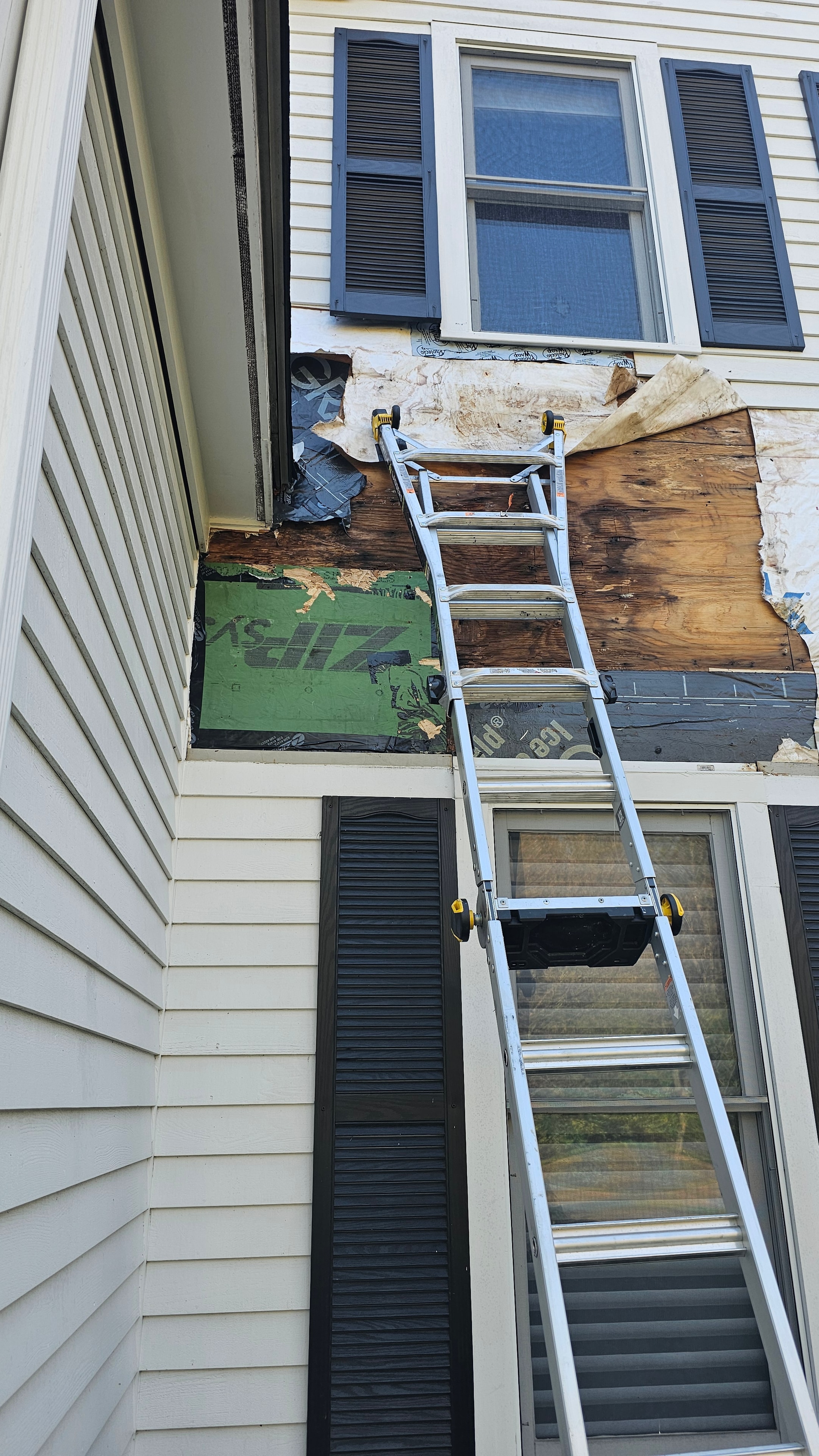 Wall sheathing exposed on the Natick exterior restoration, showing the condition of the substrate beneath the original siding.