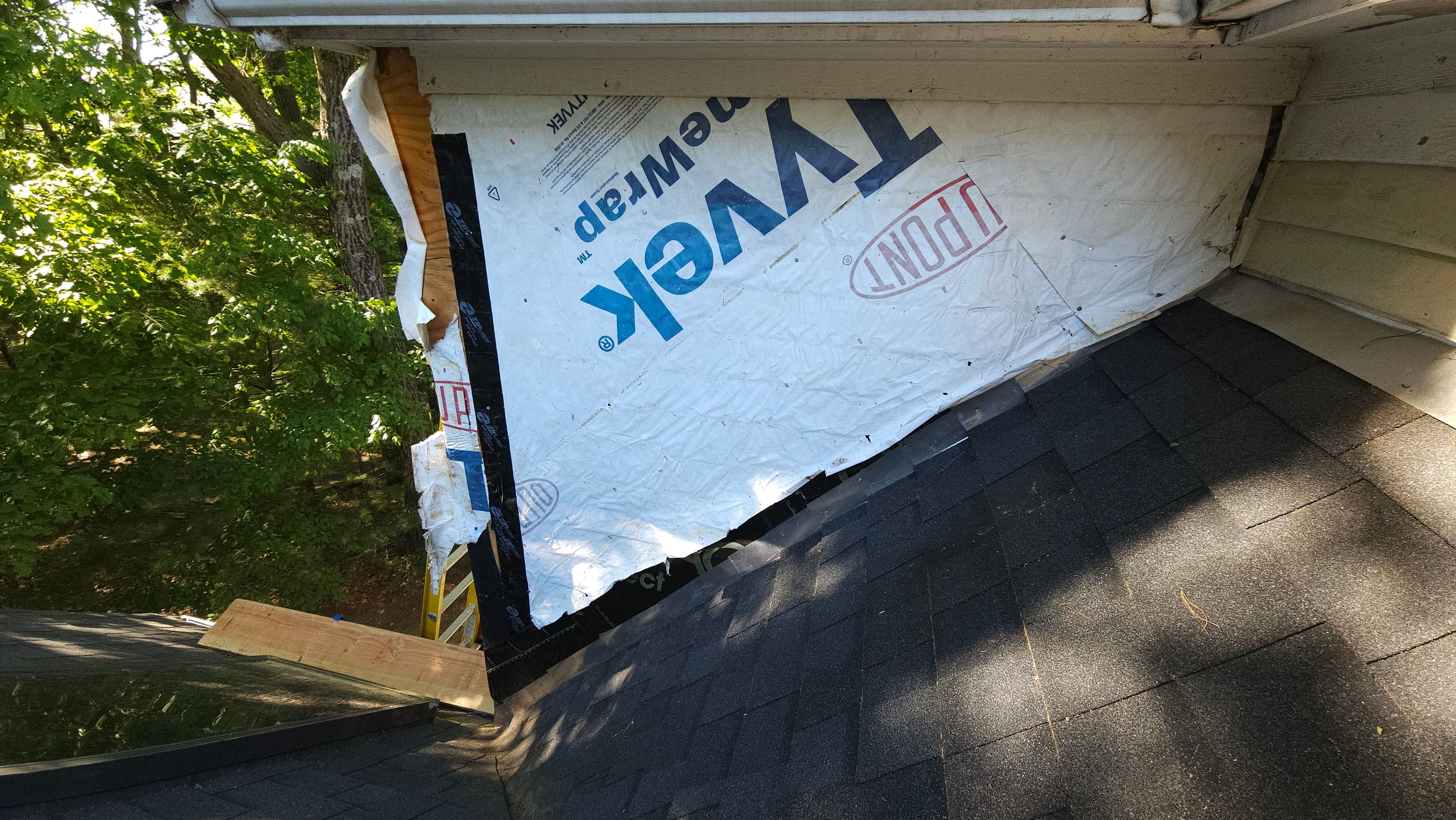 Membrane and flashing material installed under the eave on the Natick exterior restoration, showing the wrap stage before new siding.