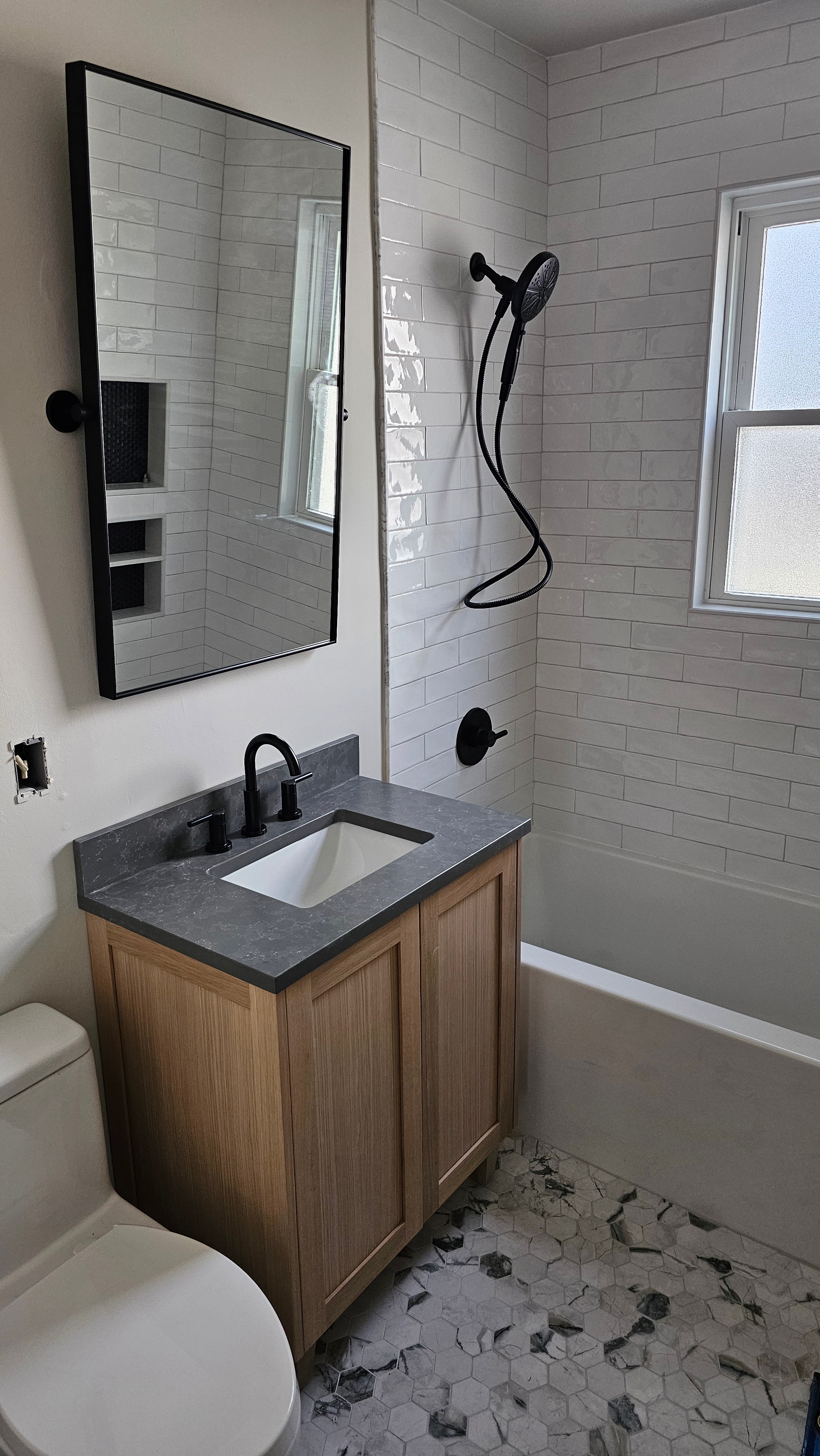 Bathroom tile installation in progress — subway tile walls, vanity set