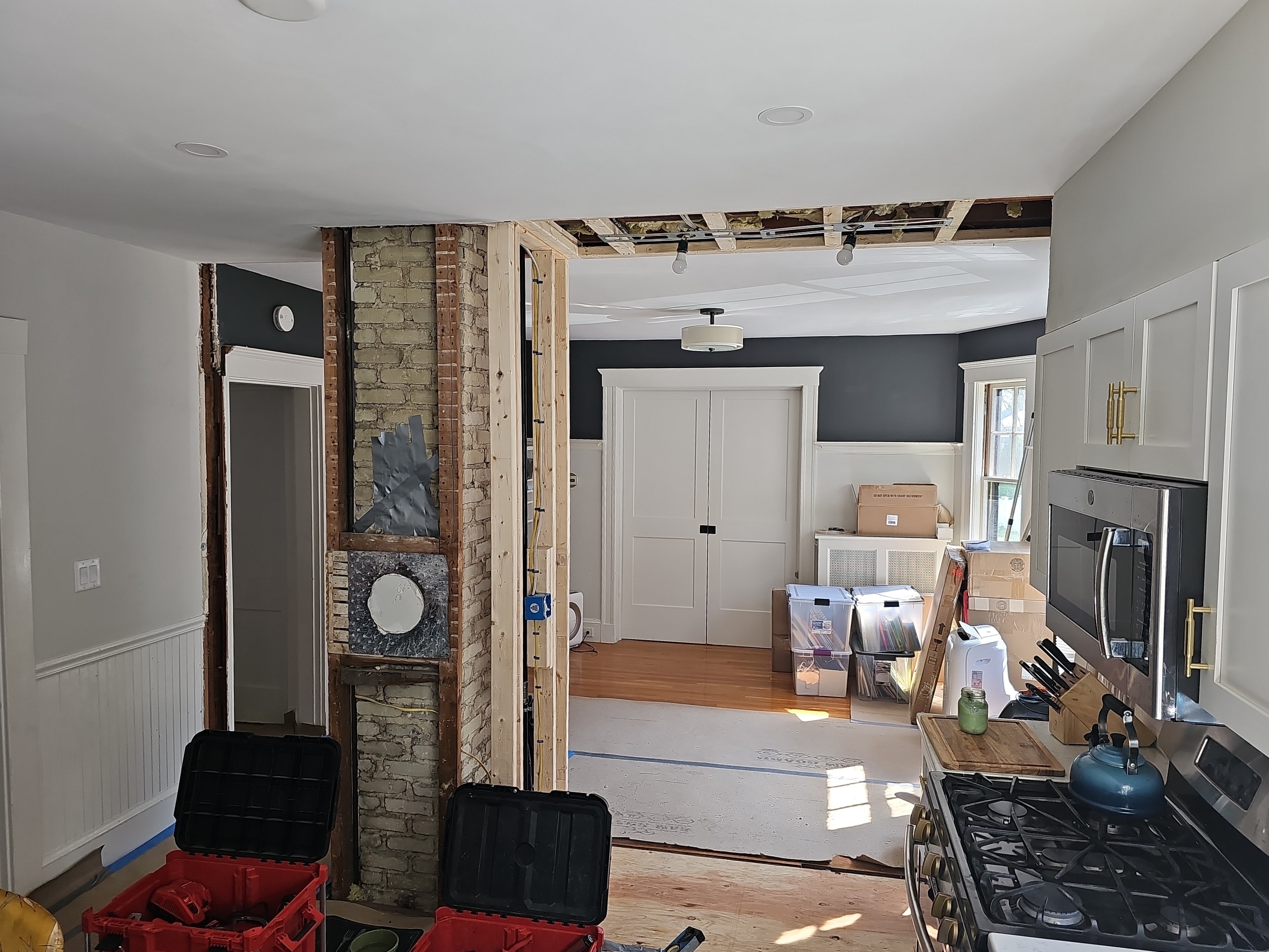 Kitchen wall opened into living room — framing in progress