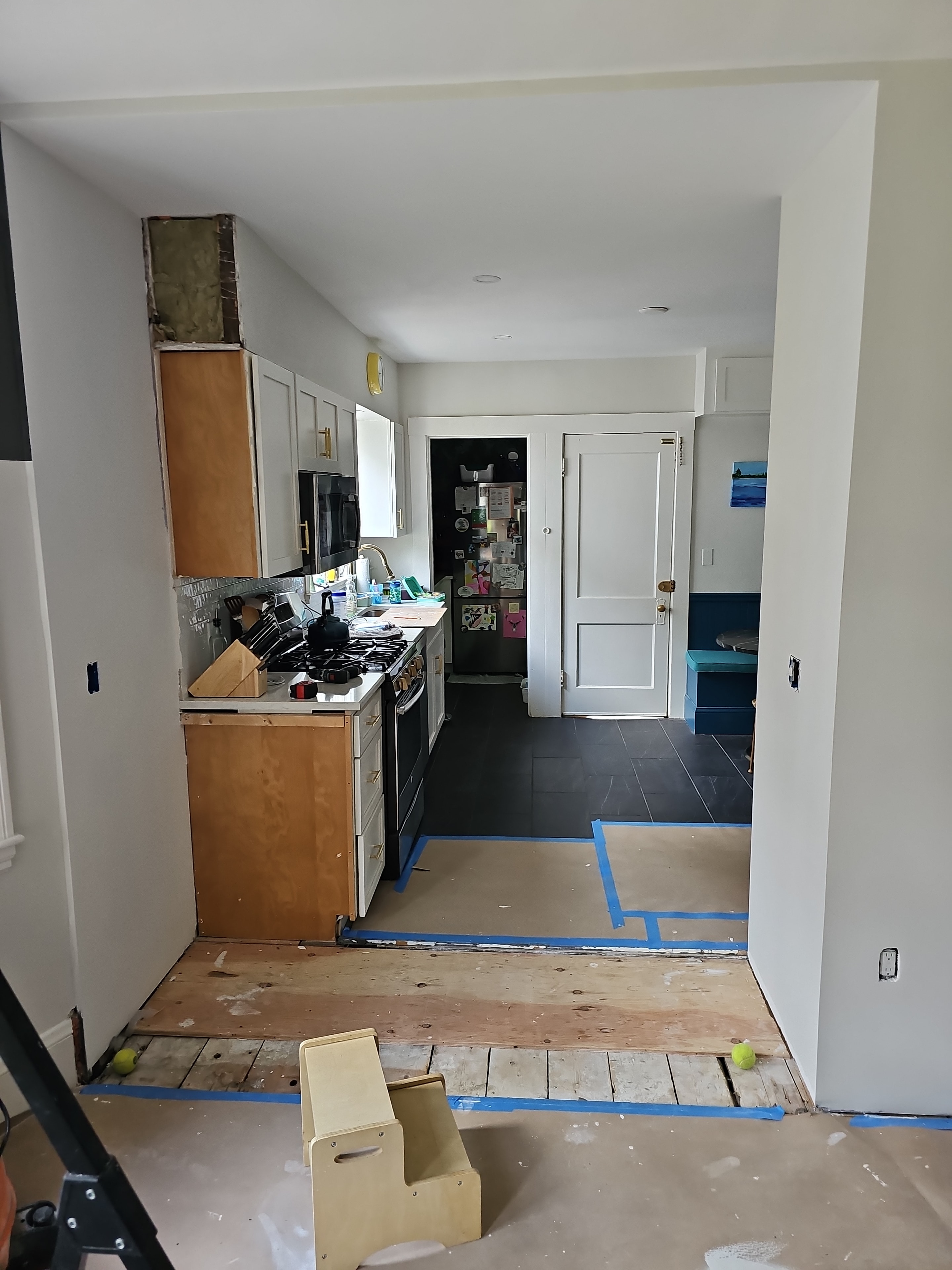 Kitchen and living room after new wallboard and plaster